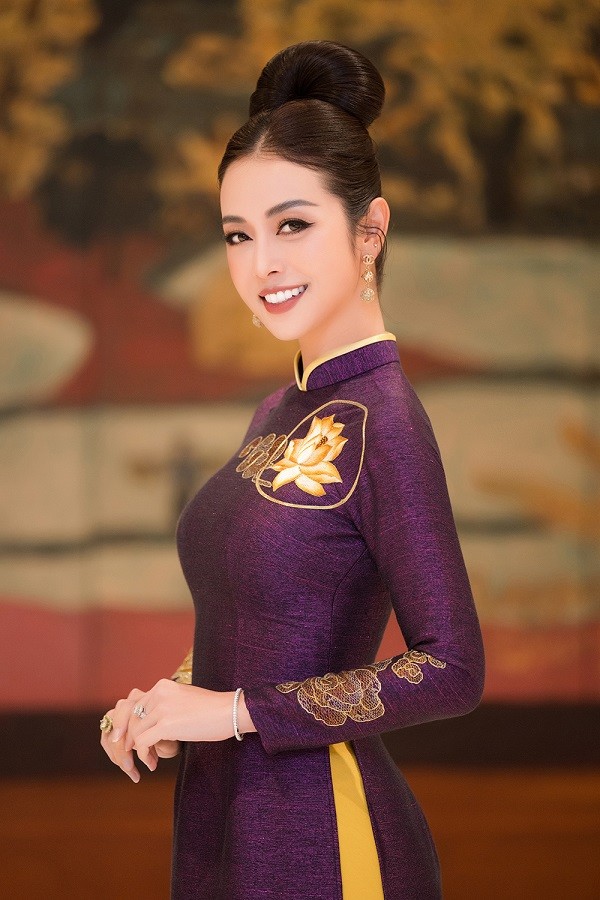 Cô chọn kiểu tóc búi cao, trang điểm tông trầm và trang sức đính kim cương khi diện áo dài.