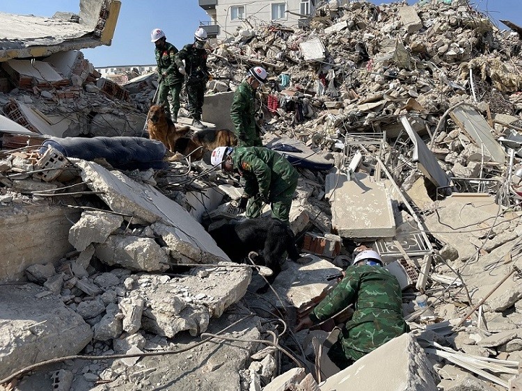 (02.18) Các chiến sỹ Việt Nam tích cực tìm kiếm dấu hiệu sự sống dưới đống đổ nát. (Nguồn: QPVN)