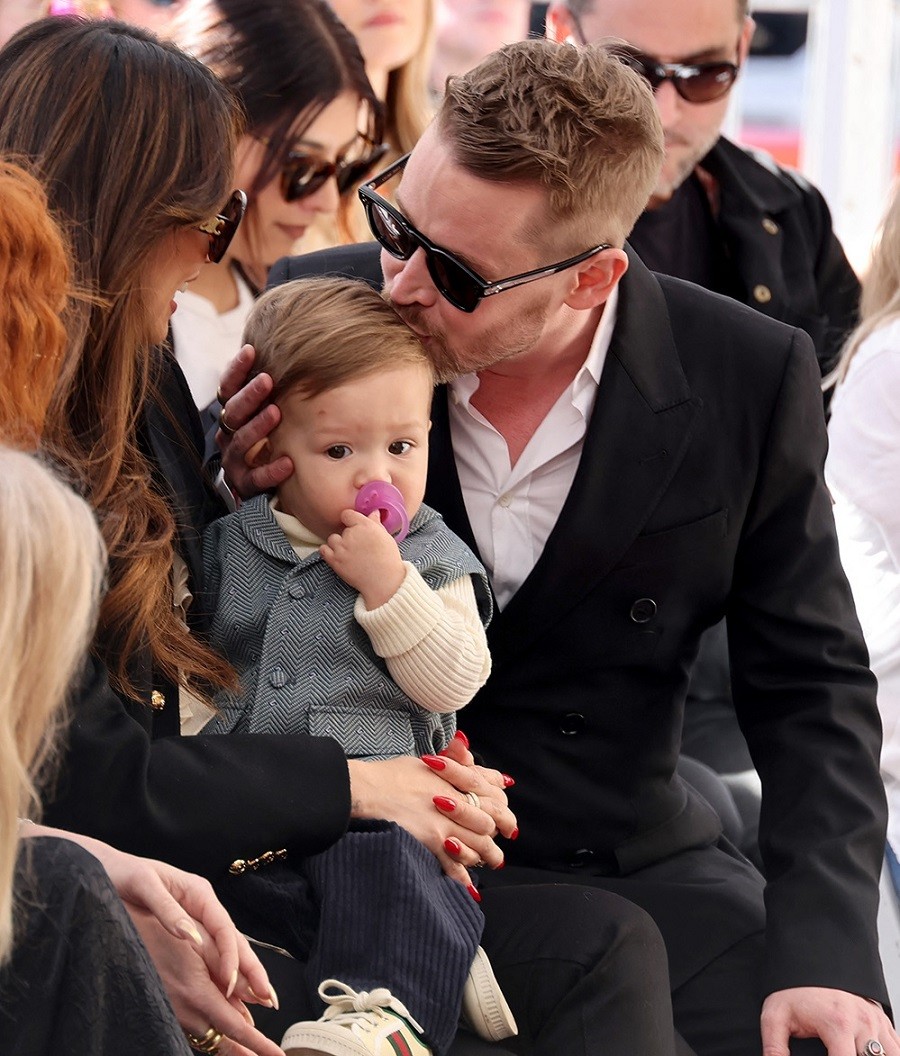 Macaulay kisses his youngest son Carson, 1 year old. He has two sons with actress Brenda Song.