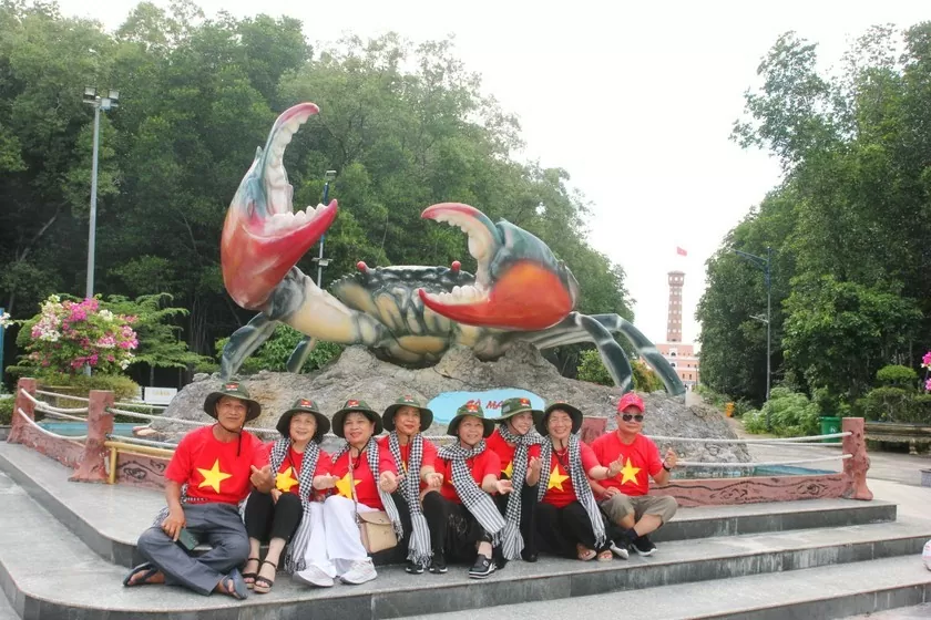 Du khách chụp ảnh tại biểu tượng con cua khổng lồ được khởi công xây dựng từ ngày 9/7/2019 bằng chất liệu composite. 