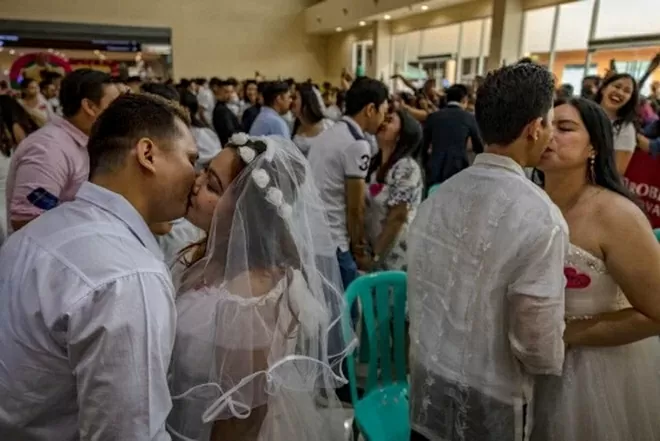 Các cặp đôi trao nhau nụ hôn khi tham gia lễ cưới tập thể dịp 14/2 tại Philippines. (Ảnh: Getty) Các cặp đôi trao nhau nụ hôn khi tham gia lễ cưới tập thể dịp 14/2 tại Philippines. (Ảnh: Getty)