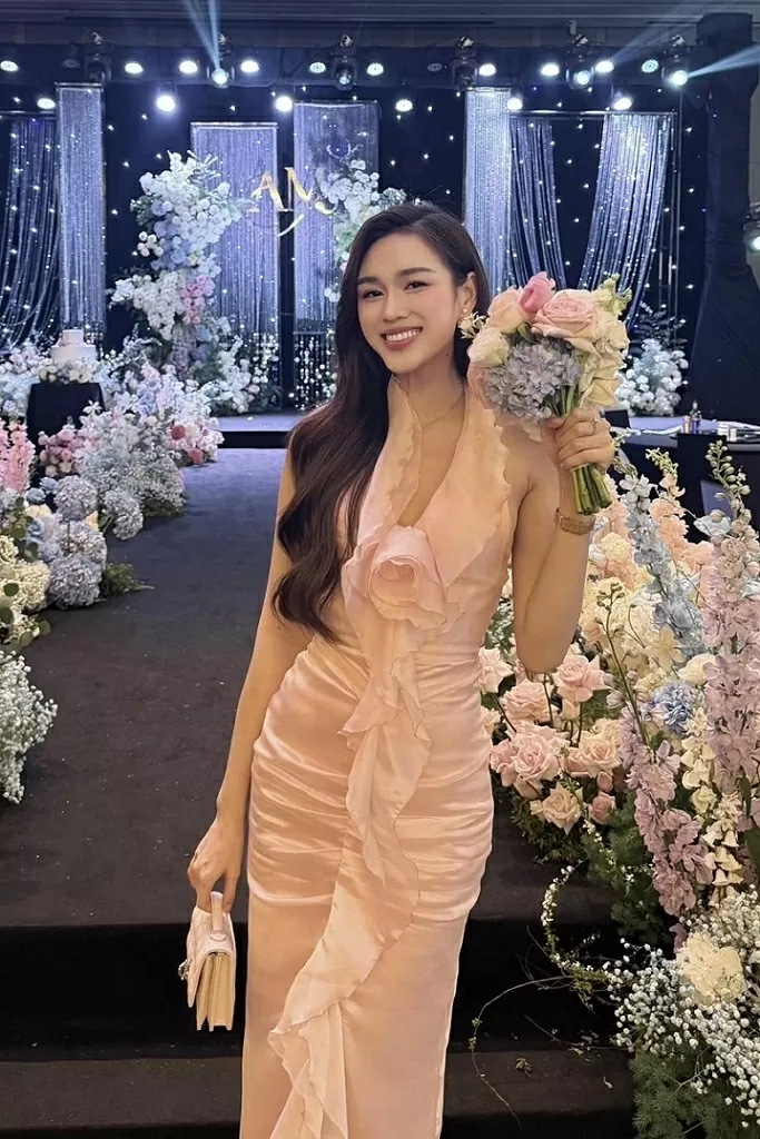 Mới đây, dự đám cưới một người bạn thân, Hoa hậu Đỗ Thị Hà chọn mặc váy tơ tông hồng pastel. Thiết kế với những đường bèo dún tạo hình hoa hồng, giúp tôn nét đẹp nữ tính của người đẹp. Trong hôn lễ, Hoa hậu Việt Nam 2020 khoe bắt được hoa cưới, khiến nhiều khán giả mong cô sớm Hoa hậu Đỗ Thị Hà dự đám cưới bạn với trang phục tông màu nữ tính, thanh lịch
