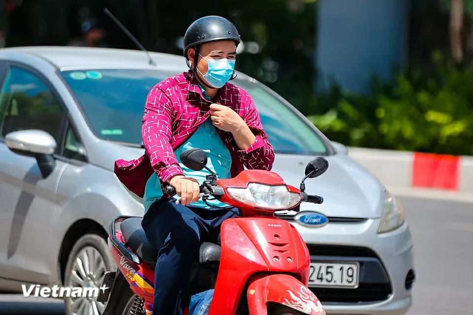 Người dân di chuyển trên đường phố như đổ lửa giữa nắng nóng Hà Nội