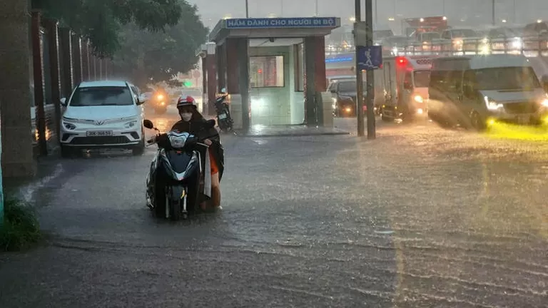 Trên tuyến đường Phạm Hùng, tình trạng ngập úng khiến nhiều ô tô không thể di chuyển, một số người dân đi xe máy đã phải dắt bộ. (Ảnh: Trọng Hải)