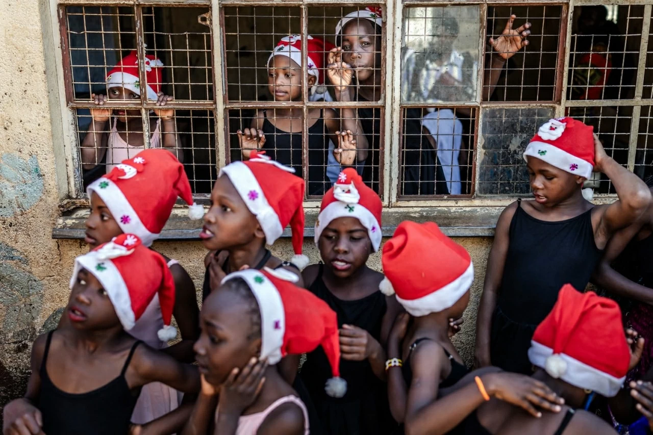 Các học viên múa ba lê nhỏ tuổi tập trung trước giờ bước ra sân khấu cho buổi biểu diễn ba lê Giáng sinh thường niên của Dự án Elimu tại khu dân cư Kibera ở Nairobi. Thông qua chương trình nghệ thuật do cộng đồng dẫn dắt, các vũ công trẻ được tiếp cận với ba lê cổ điển, qua đó nuôi dưỡng tính kỷ luật, sự sáng tạo và lòng tự tin. (Nguồn: Getty Images) Các học viên múa ba lê nhỏ tuổi tập trung trước giờ bước ra sân khấu cho buổi biểu diễn ba lê Giáng sinh thường niên của Dự án Elimu tại khu dân cư Kibera ở Nairobi. Thông qua chương trình nghệ thuật do cộng đồng dẫn dắt, các vũ công trẻ được tiếp cận với ba lê cổ điển, qua đó nuôi dưỡng tính kỷ luật, sự sáng tạo và lòng tự tin. (Nguồn: Getty Images)