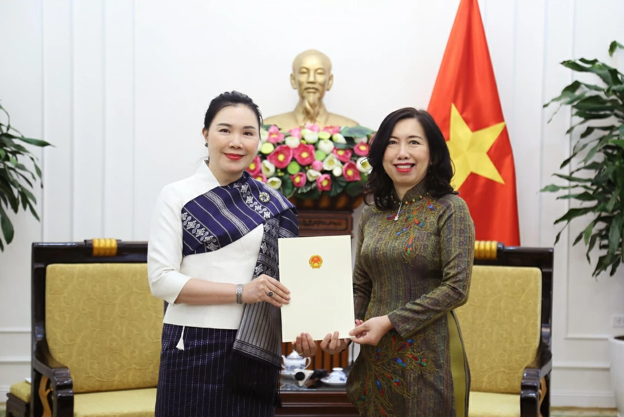 Thứ trưởng Lê Thị Thu Hằng đã trao Giấy Chấp nhận lãnh sự cho bà Vonekham Cheuangmanivong. (Ảnh: Thành Long) 