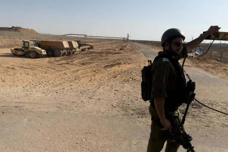 Một binh sĩ Israel mở cổng vào Dải Gaza tại cửa khẩu Kerem Shalom ngày 24/7, trong bối cảnh Israel phê chuẩn việc triển khai lực lượng ổn định quốc tế theo kế hoạch hòa bình do Mỹ đề xuất. (Nguồn: Al Jazeera)