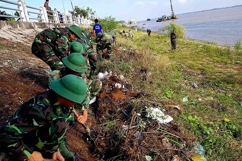 Cán bộ, chiến sĩ BĐBP An Giang dọn vệ sinh môi trường trên địa bàn biên giới. (Ảnh: Chiến Khu)