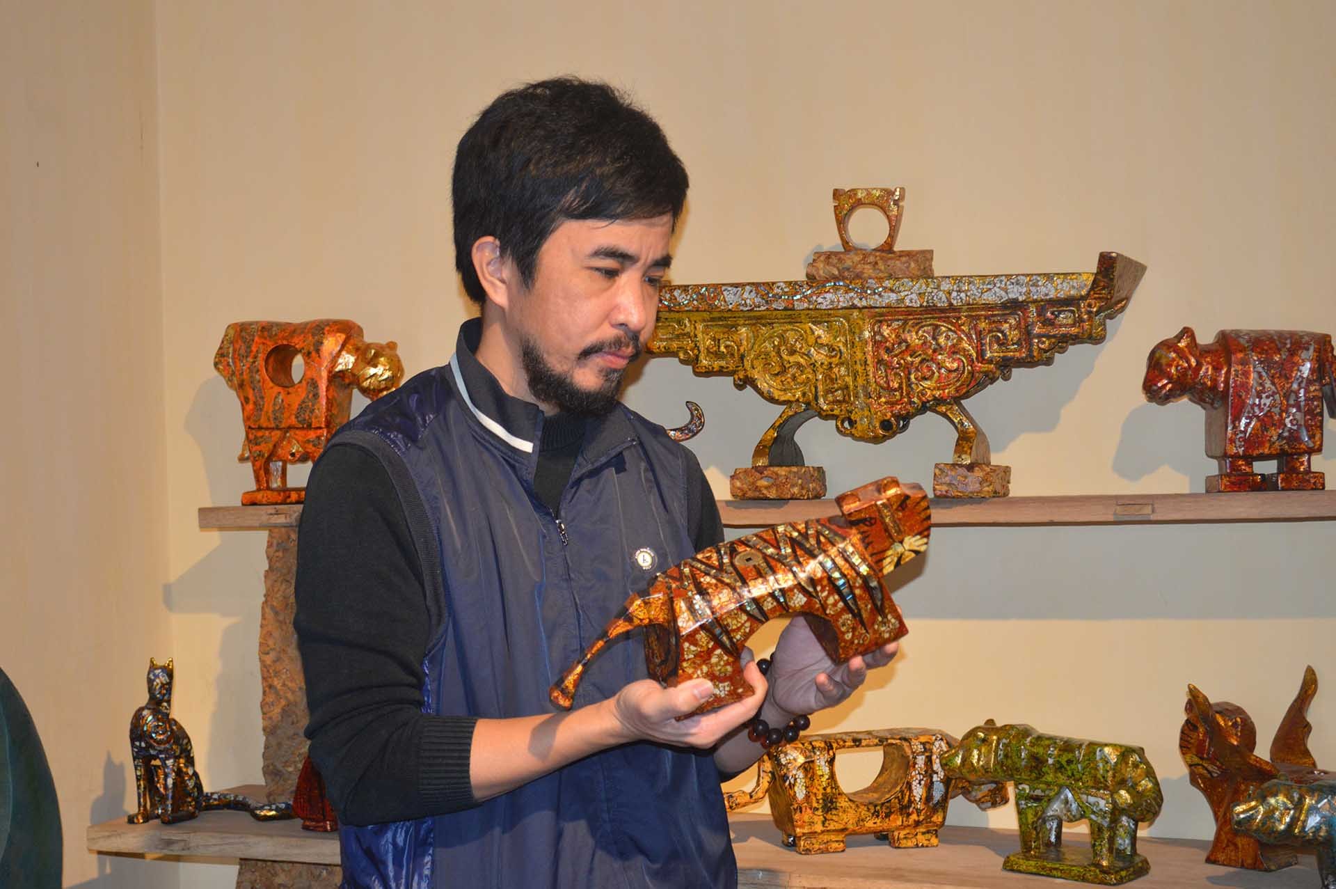 Họa sĩ, nghệ nhân Nguyễn Tấn Phát bên những bức tượng sơn mài hổ với các dáng vẻ vô cùng phong phú đang được trưng bày ở “Phat Studio” tại Làng cổ Đường Lâm. (Ảnh: Nguyễn Mạnh Cường) Họa sĩ, nghệ nhân Nguyễn Tấn Phát bên những bức tượng sơn mài hổ với các dáng vẻ vô cùng phong phú đang được trưng bày ở “Phat Studio” tại Làng cổ Đường Lâm. (Ảnh: Nguyễn Mạnh Cường)