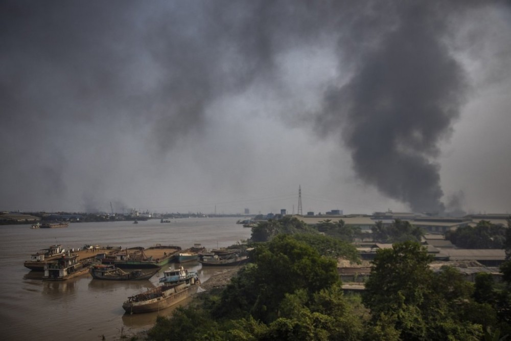 Black smoke billows from an industrial zone in Yangon on Sunday. Photo: AP