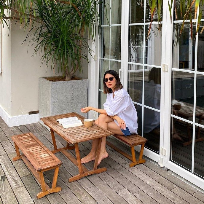 Đón tuổi mới hôm 24/10, cô chọn sơ mi trắng phom rộng và quần short jeans khỏe khoắn.